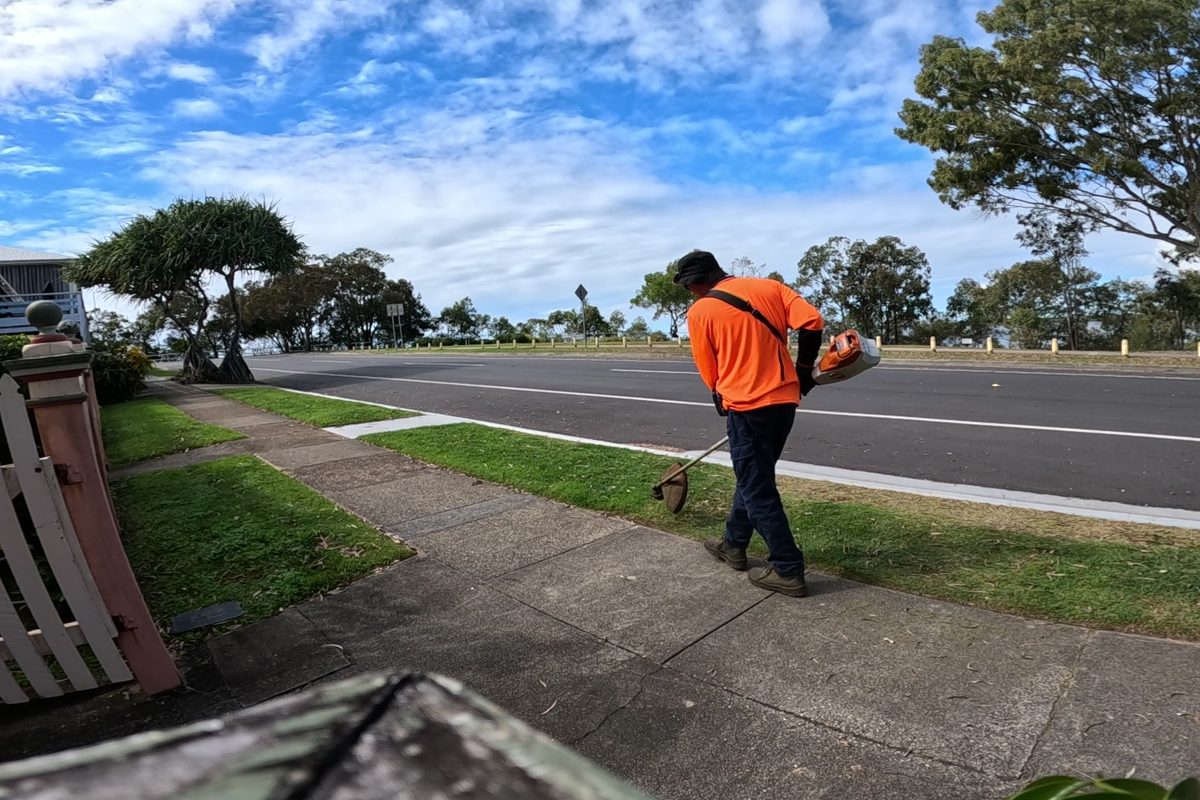Edging and trimming a roadside lawn